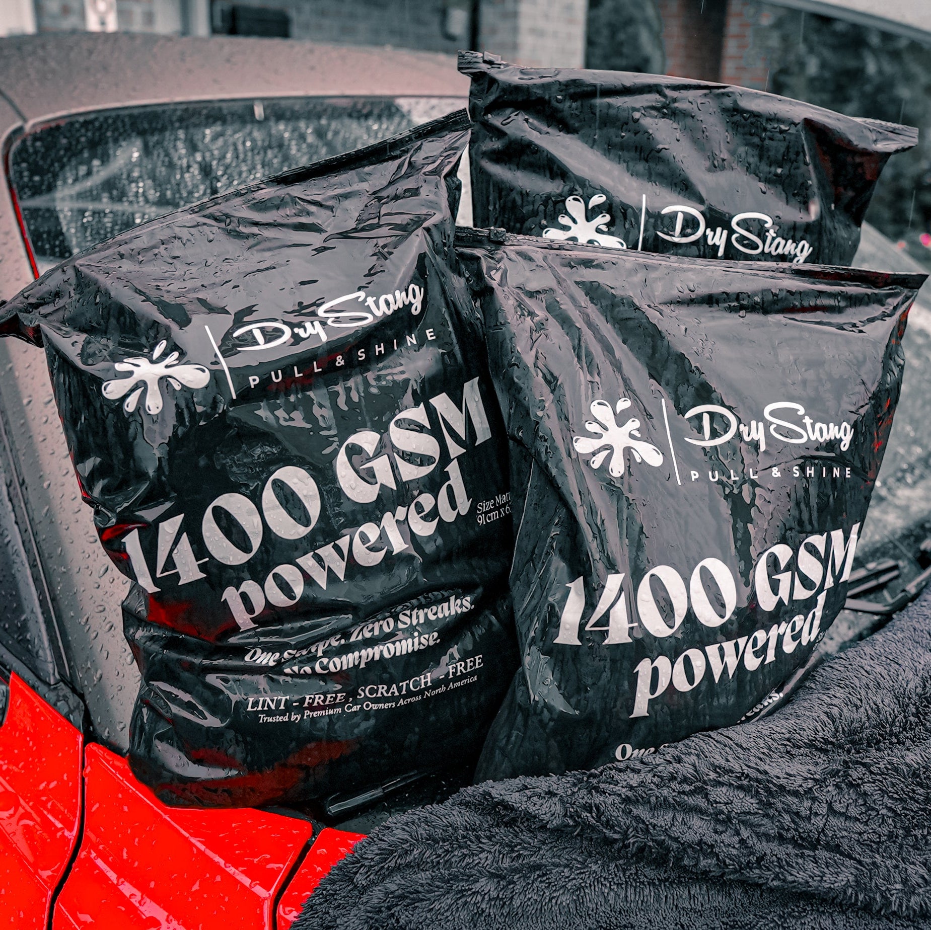 Dry Sling car cover with '1400 GSM powered' text on a red car