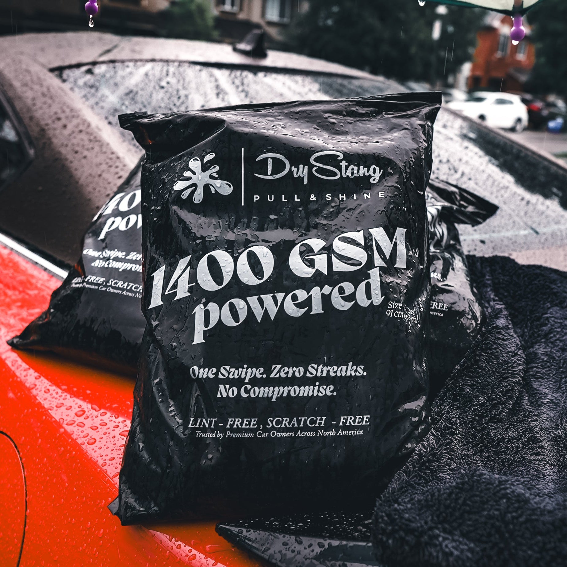 Bag of Dry Stark 1400 GSM polishing compound on a car with a blurred street background